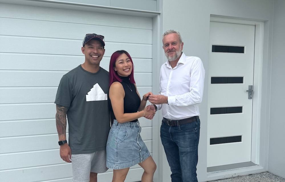 Paul Merritt with clients at the handover of their new home
