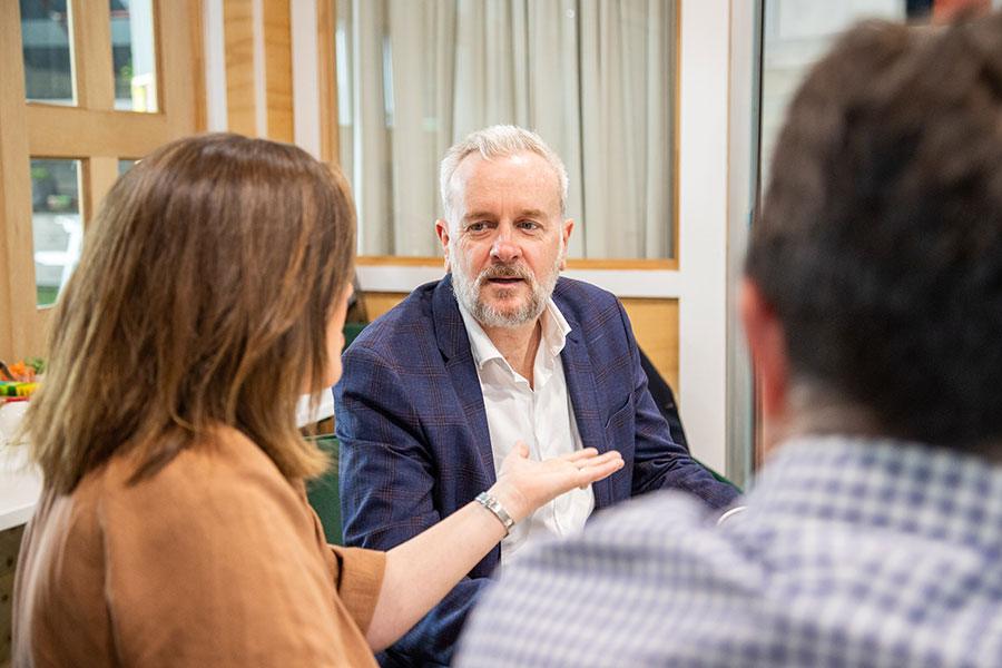 Paul Merritt in conversation with a client
